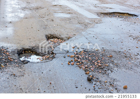 Holes in asphalt road Holes in asphalt road 21955133