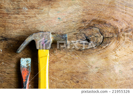 Close up of rusty hammer and chisel on old wood Close up of rusty hammer and chisel on old wood 21955326