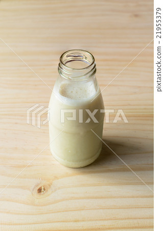 Bottle of fresh milk on wooden table 21955379