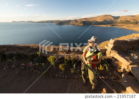 Tourist looking at sunset on Titicaca Lake, Bolivia 21957187