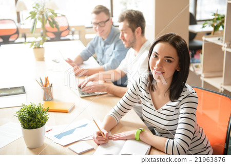 Positive girl sitting at the table  21963876