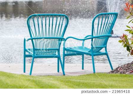 Two blue chairs at the waterfront 21965418