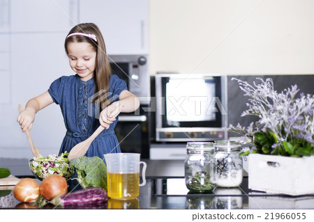 little daughter cooking in the kitchen 21966055