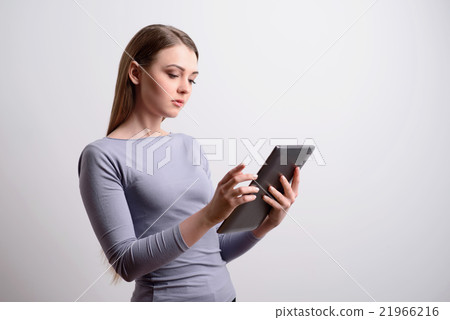 Pleasant girl using tablet  21966216