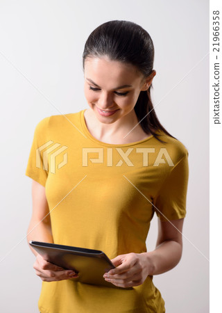 Nice pleasant  girl using tablet 21966358