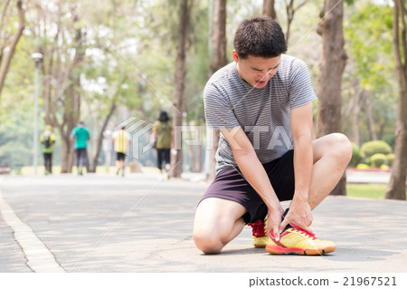 Sports injury.Man with pain in ankle while jogging Sports injury.Man with pain in ankle while jogging 21967521