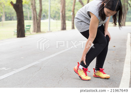Woman with pain in ankle while jogging 21967649