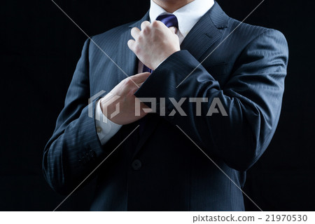Businessman tightens a tie Businessman tightens a tie 21970530