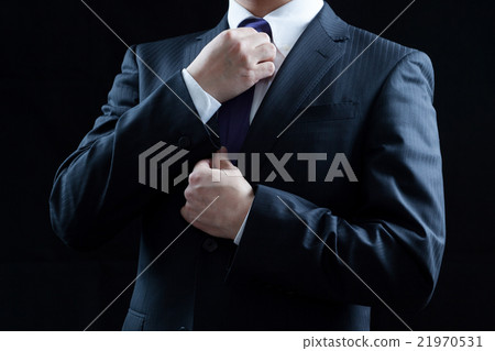 Businessman tightens a tie Businessman tightens a tie 21970531