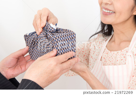 Wife giving lunch box 21972269