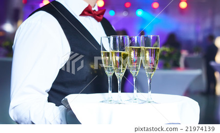 Waiter serving champagne on a tray 21974139