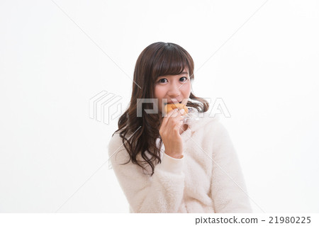 A woman eating a donut A woman eating a donut 21980225