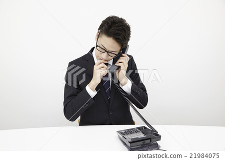 Young office worker office phone Young office worker office phone 21984075