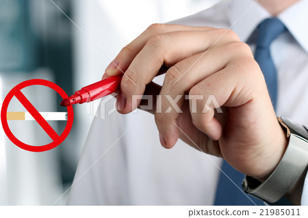 Man drawing a sign "stop smoking" by a red pen . Man drawing a sign "stop smoking" by a red pen . 21985011