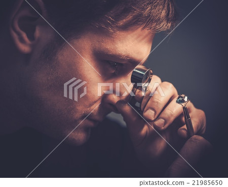 Portrait of a jeweler during the evaluation Portrait of a jeweler during the evaluation 21985650