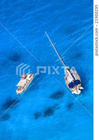 White  yacht against azure sea with motor boat 21988295