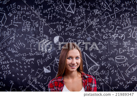 Student against a big blackboard with mathematical Student against a big blackboard with mathematical 21989347