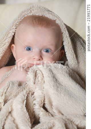 baby with a towel after the shower in bed at home 21991771