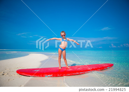 Little adorable girl practice surfing position at Little adorable girl practice surfing position at 21994825