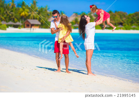 Happy family playing together on white beach  21995145