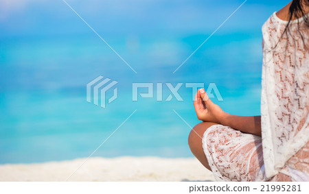 Young woman in the lotus posture close up 21995281