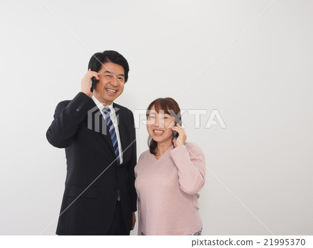 A couple engaged in a telephone call A couple engaged in a telephone call 21995370
