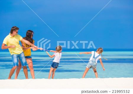 Happy family having fun on white beach Happy family having fun on white beach 21995532