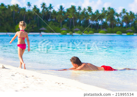 Little girl and dad during tropical beach vacation Little girl and dad during tropical beach vacation 21995534