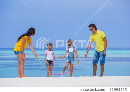 Happy family having fun on white beach Happy family having fun on white beach 21995535