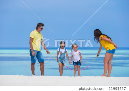 Happy family of four on white beach Happy family of four on white beach 21995537