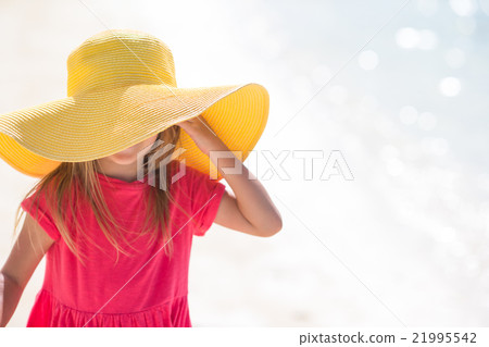 Adorable little girl in hat at beach during summer Adorable little girl in hat at beach during summer 21995542