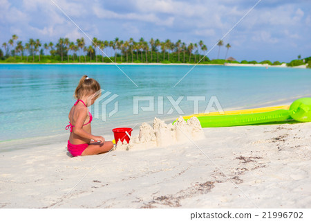 Adorable little girl playing with beach toys Adorable little girl playing with beach toys 21996702