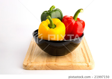 Sweet peppers in ceramic bowl and wood block Sweet peppers in ceramic bowl and wood block 21997150