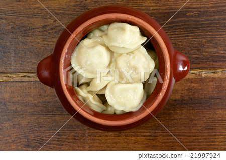 Russian dumplings in clay pot close up Russian dumplings in clay pot close up 21997924