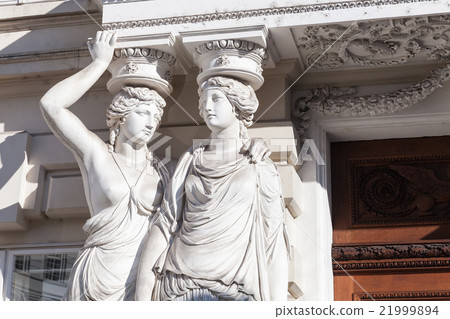 Statues of two young women in form of columns 21999894