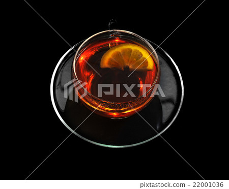 Cup of black tea and lemon on a black background. 22001036