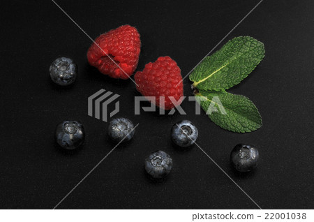 raspberries and blueberries with mint leaves  22001038