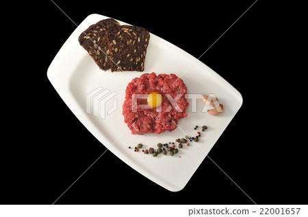 minced beef with raw egg on a white Board tray minced beef with raw egg on a white Board tray 22001657