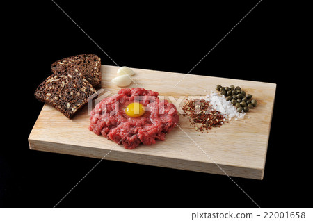 minced beef with raw egg on a wooden Board minced beef with raw egg on a wooden Board 22001658