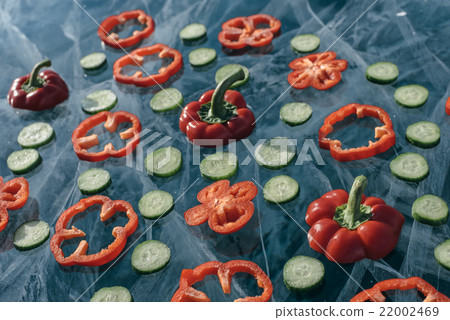 Sweet peppers and cucumber on ice. 22002469