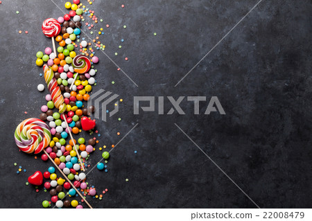 Colorful candies and lollipops over stone Colorful candies and lollipops over stone 22008479