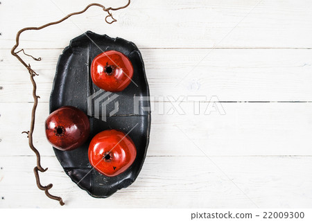 Many ceramic red pomegranates flat lay Many ceramic red pomegranates flat lay 22009300
