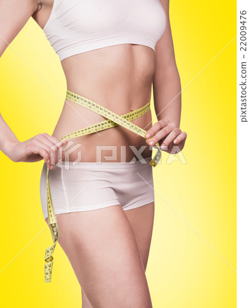 Young woman with measure in hand  22009476