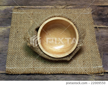 bowl in gunny bag on wood background 22009550