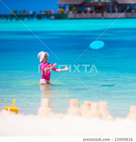 Little girl playing with flying disc at white 22009816