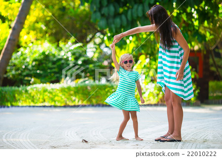 Adorable little girl and happy mom during tropical 22010222
