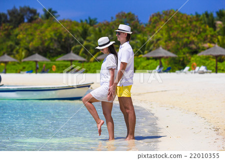 Young happy couple on white beach at summer Young happy couple on white beach at summer 22010355