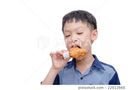 Young Asian boy eating fried chicken over white Young Asian boy eating fried chicken over white 22012668