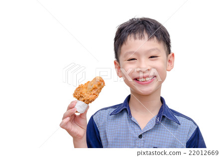 Young Asian boy eating fried chicken over white Young Asian boy eating fried chicken over white 22012669