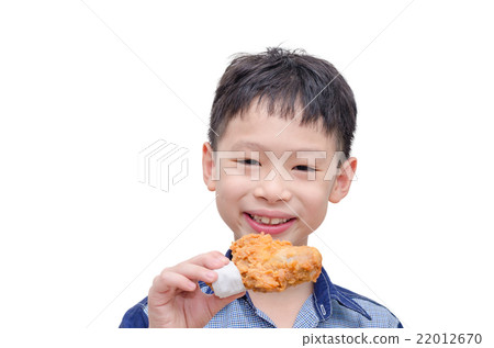 Young Asian boy eating fried chicken over white Young Asian boy eating fried chicken over white 22012670